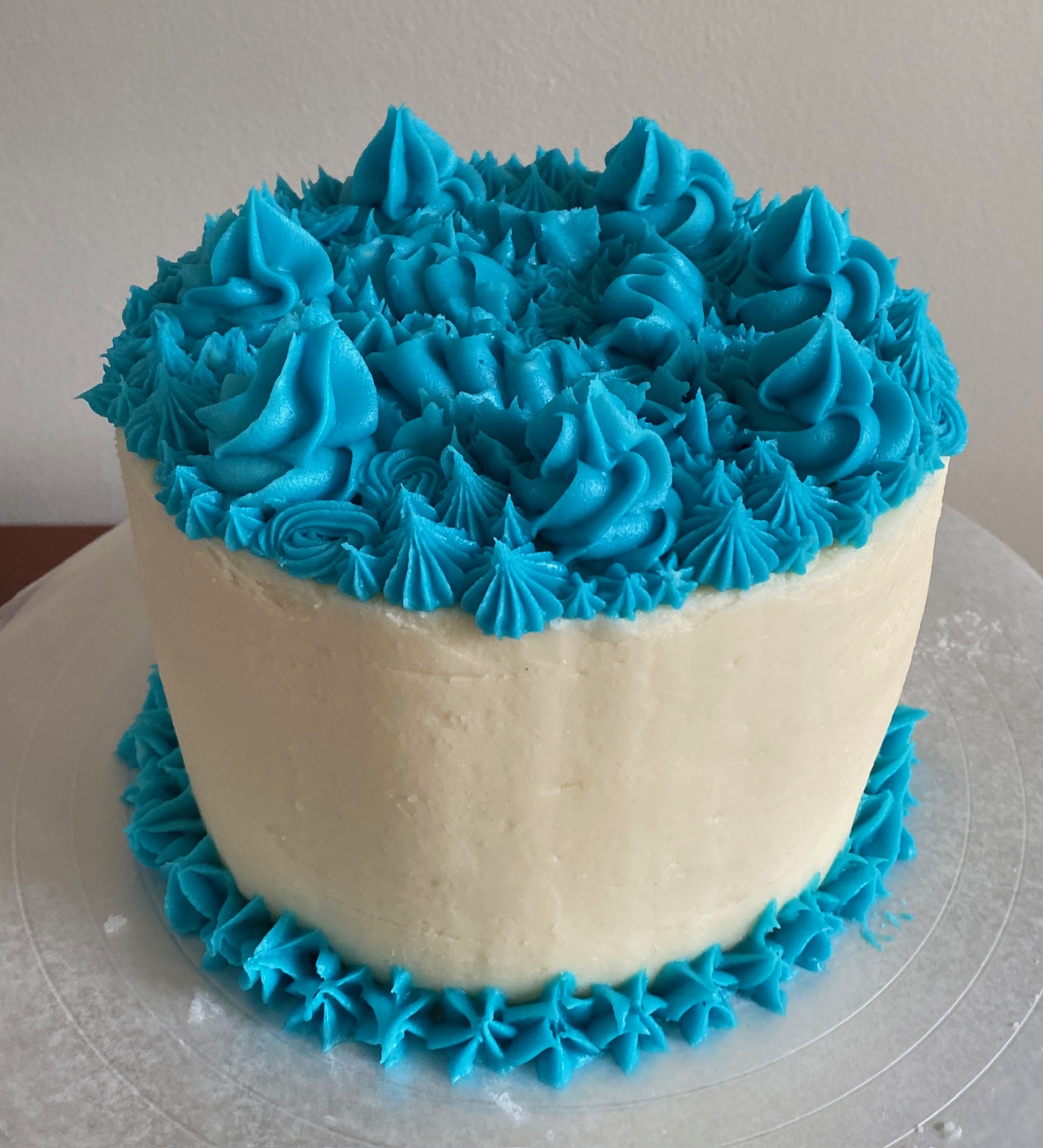 A cake with blue frosting decoration.