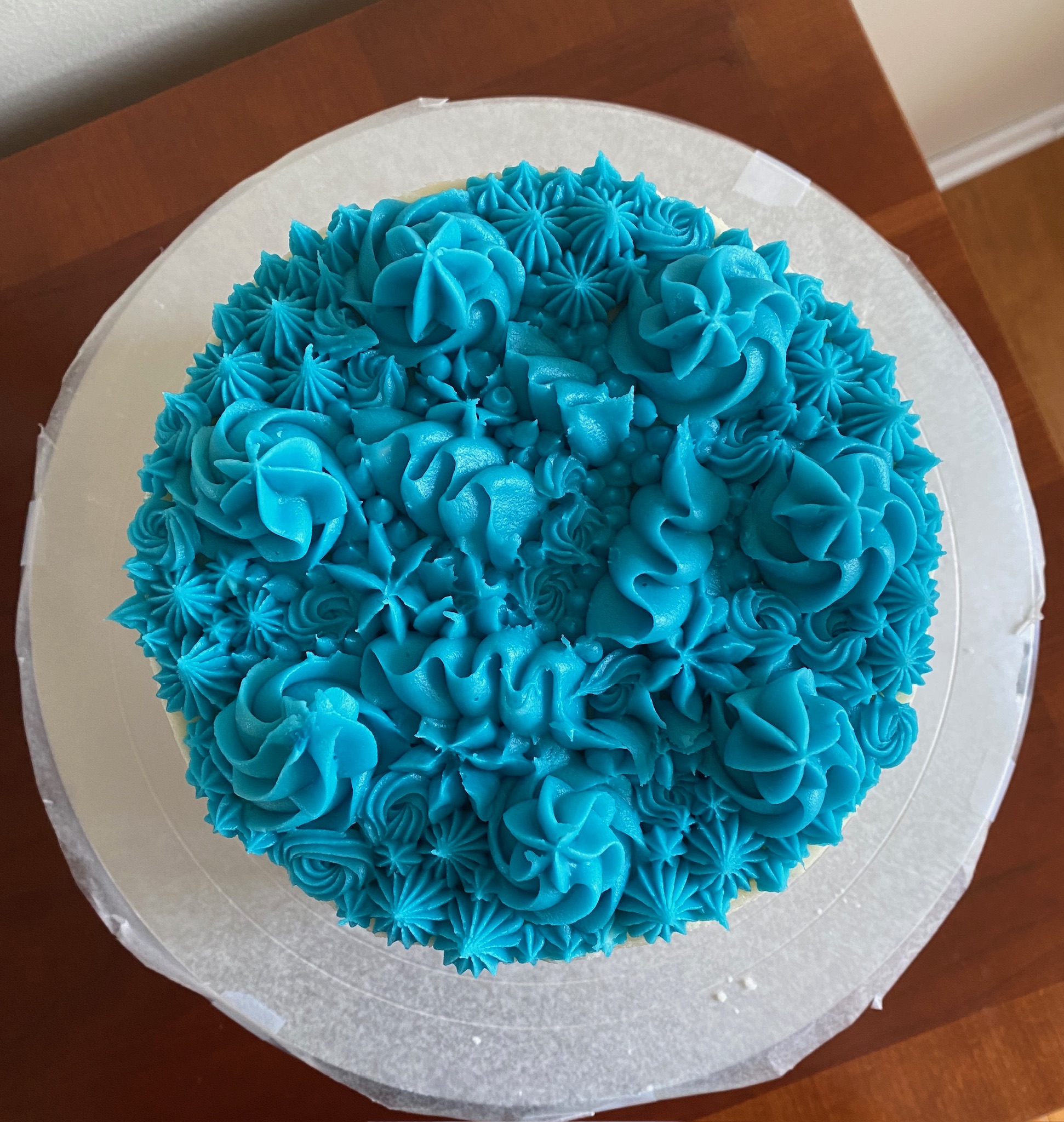 A cake with blue frosting decoration.